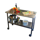 Mobile stainless steel work table equipped with a cutting board, ideal for food preparation and cooking tasks.